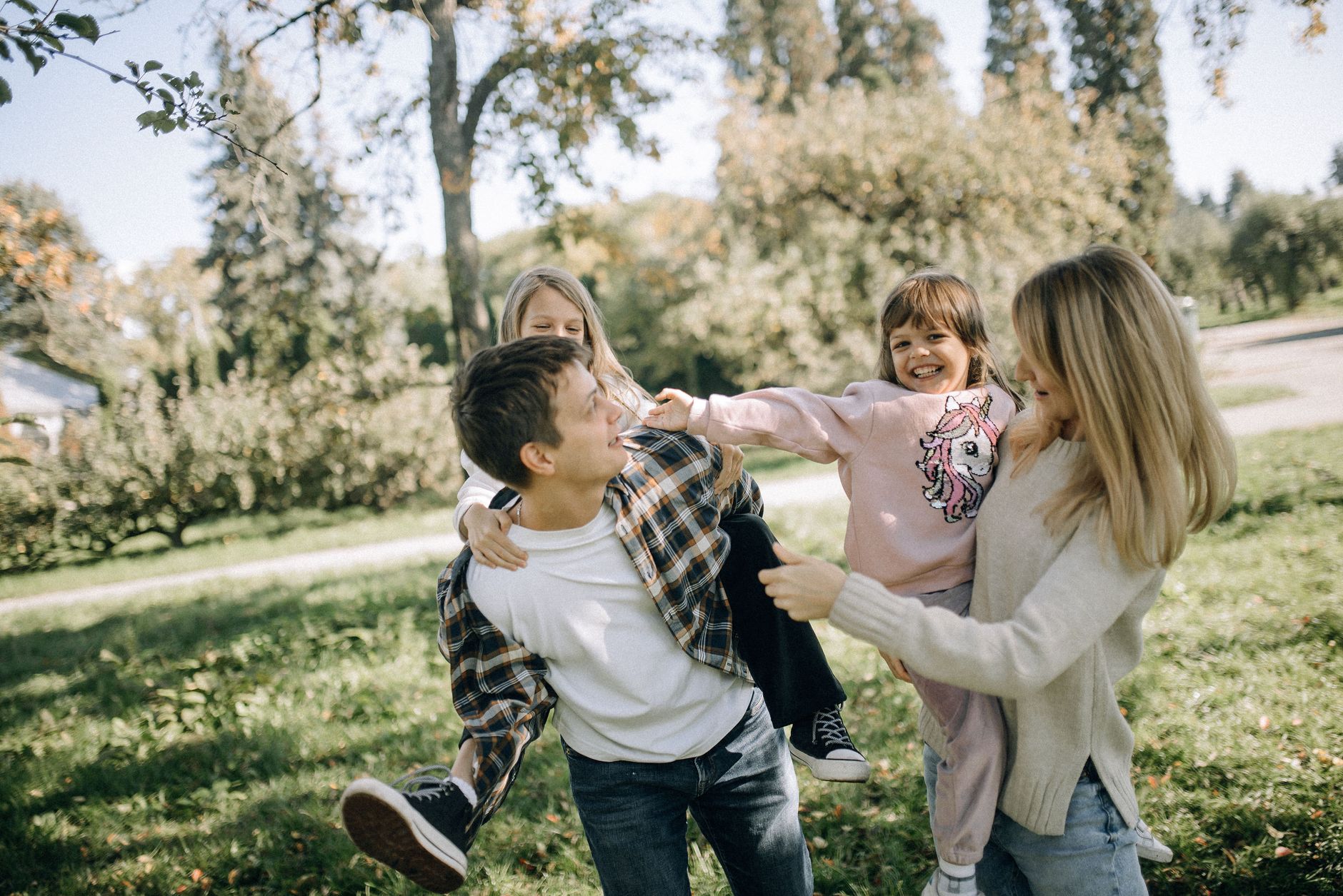Adult and children playing together outdoors
